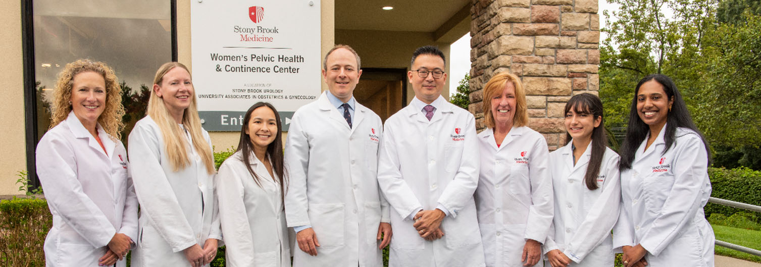 Photo of our staff standing outside of the Women's Pelvic Health Center in white coats