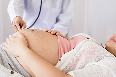 pregnant woman getting an ultrasound on her abdomen area