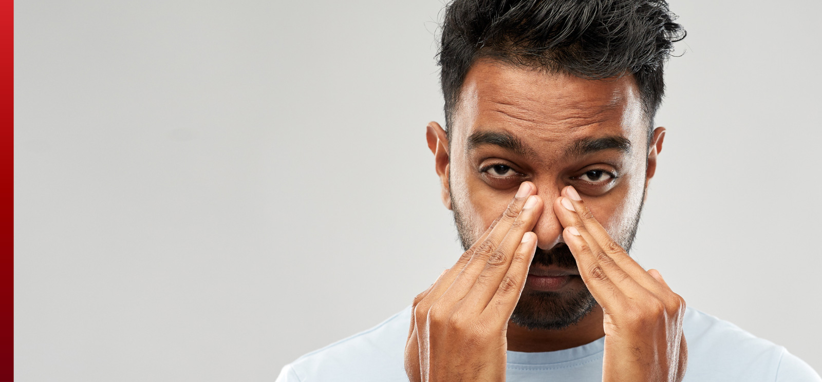Man holding his nose