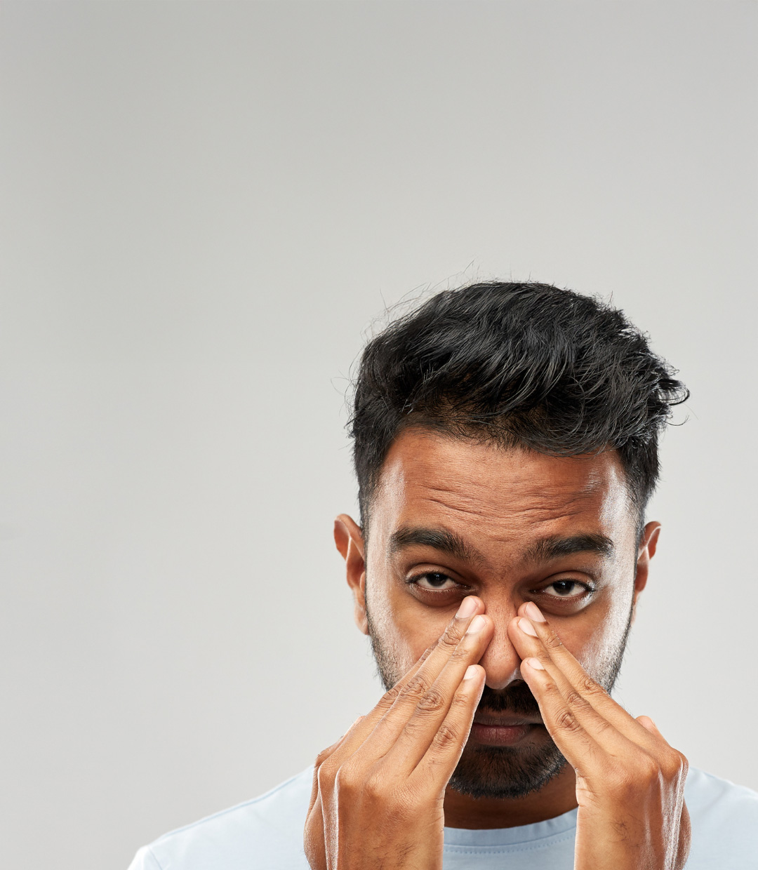 Man holding his nose