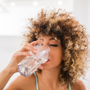 woman drinking a glass of water