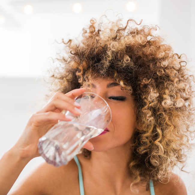 woman drinking a glass of water