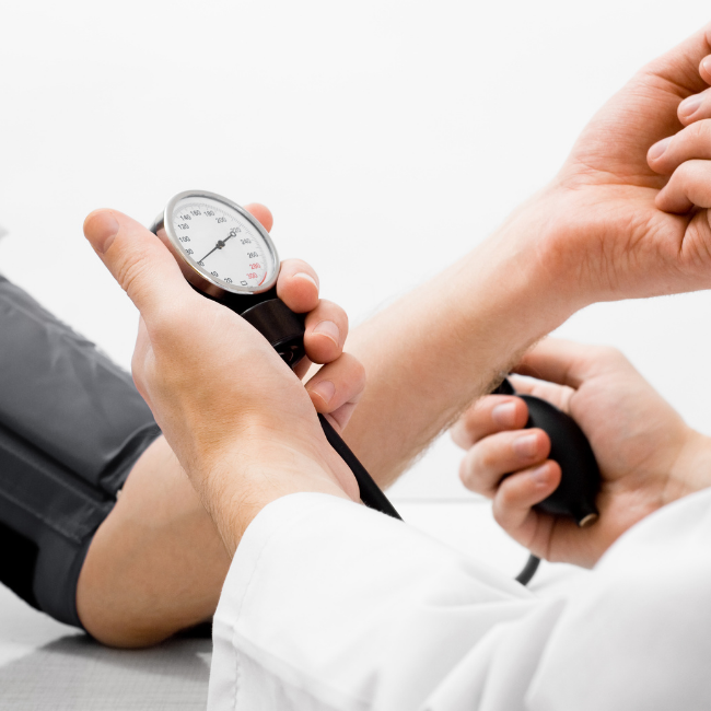 doctor taking patient's blood pressure