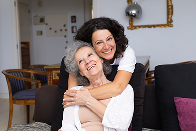 woman hugging her mom from behind