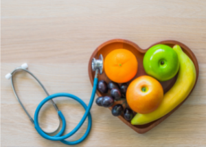 stethoscope and fruit shaped into a heart