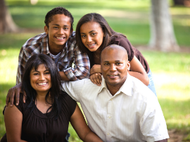 family smiling outdoors