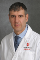 Photo of Dr. Massimiliano Spaliviero in a white coat