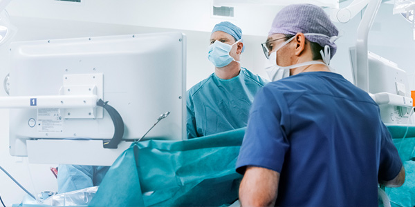 physicians in operating room preparing for surgery