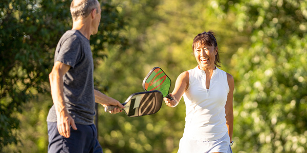 male patient expressing pain while holding hip