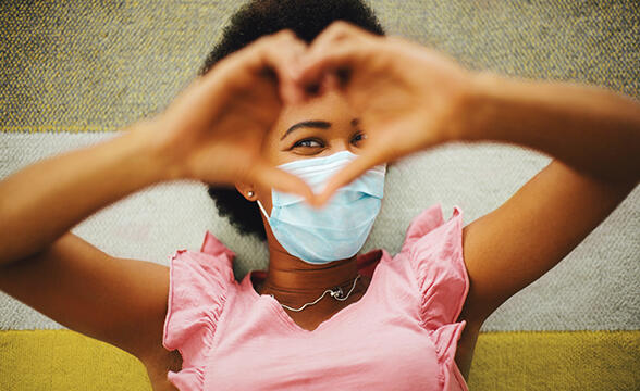 A girl making a heart with her hands