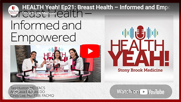 Physicians sitting around a table discussing breast health