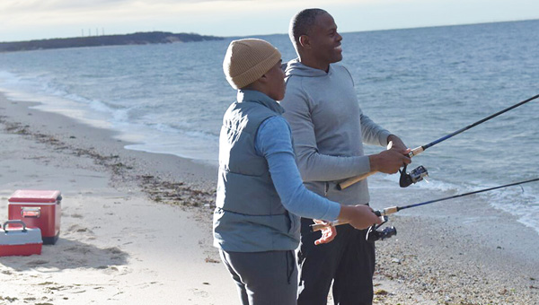 Child and adult male fishing together