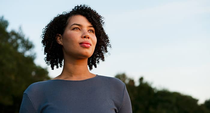 Woman looking up at dusk