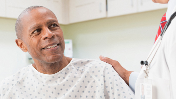 Middle aged male discussing medical treatment with physician