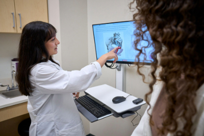 Provider pointing to diagram on screen for patient
